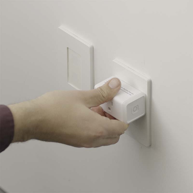 Hand plugging in Mesa's smart plug